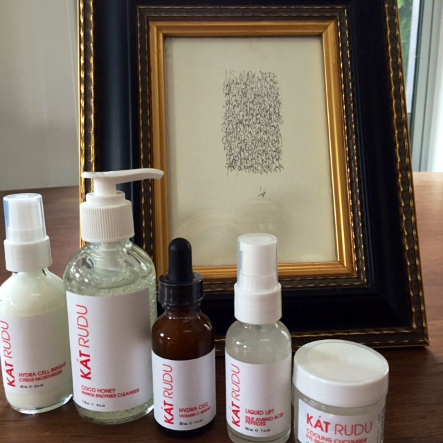 Kat Rudu Beauty Collection -- image of bottles in front of framed picture