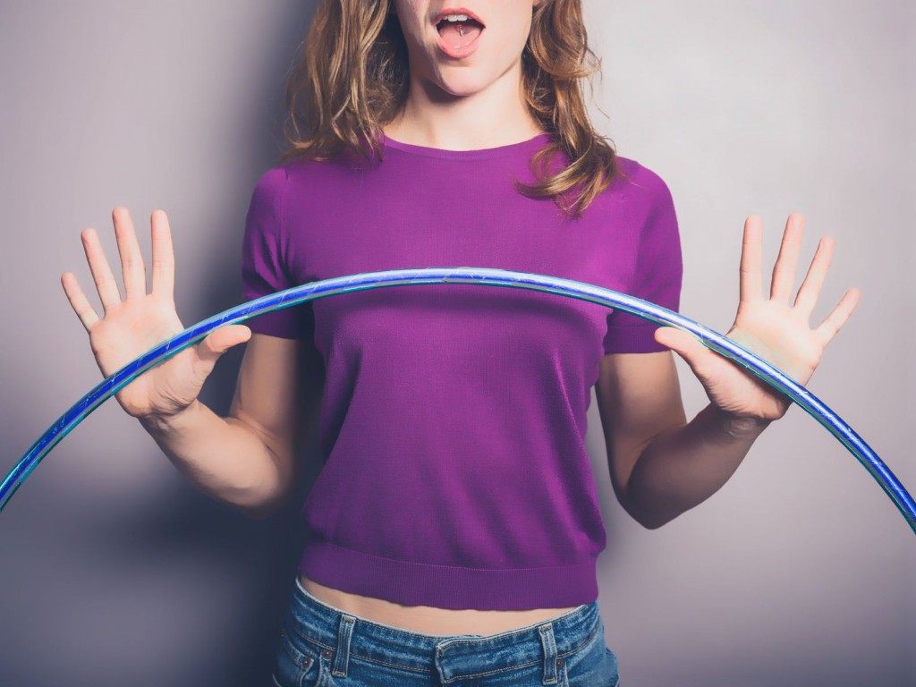 young woman holding hula hoop