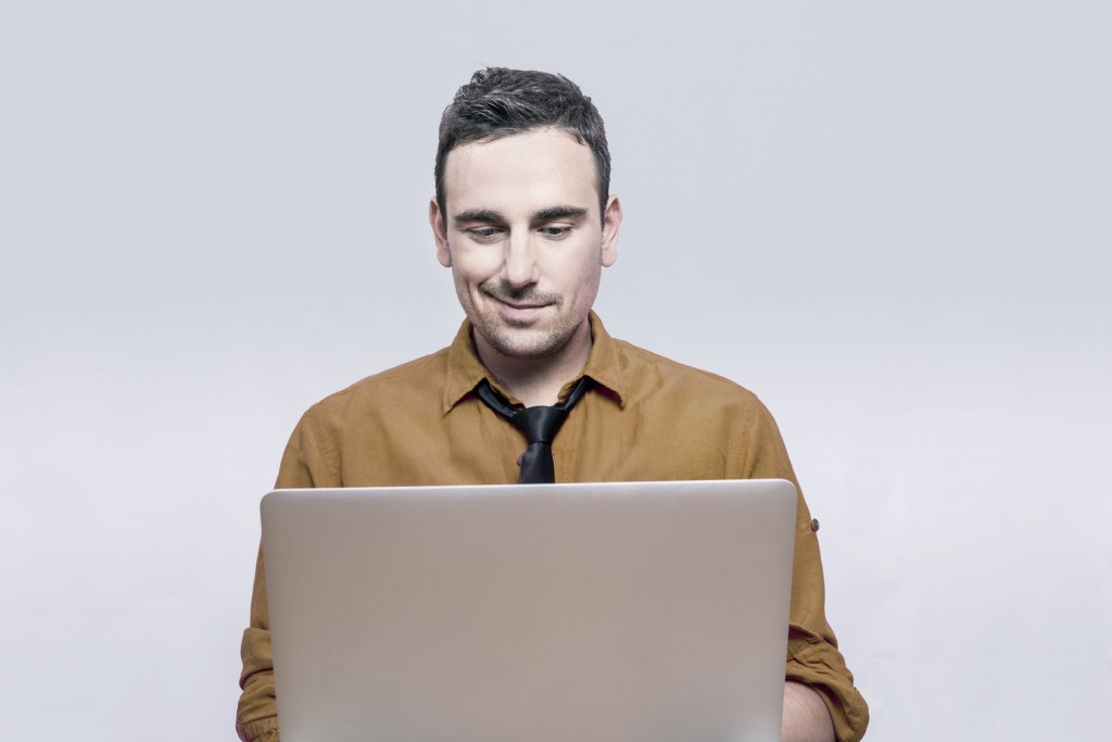 man smiling at computer