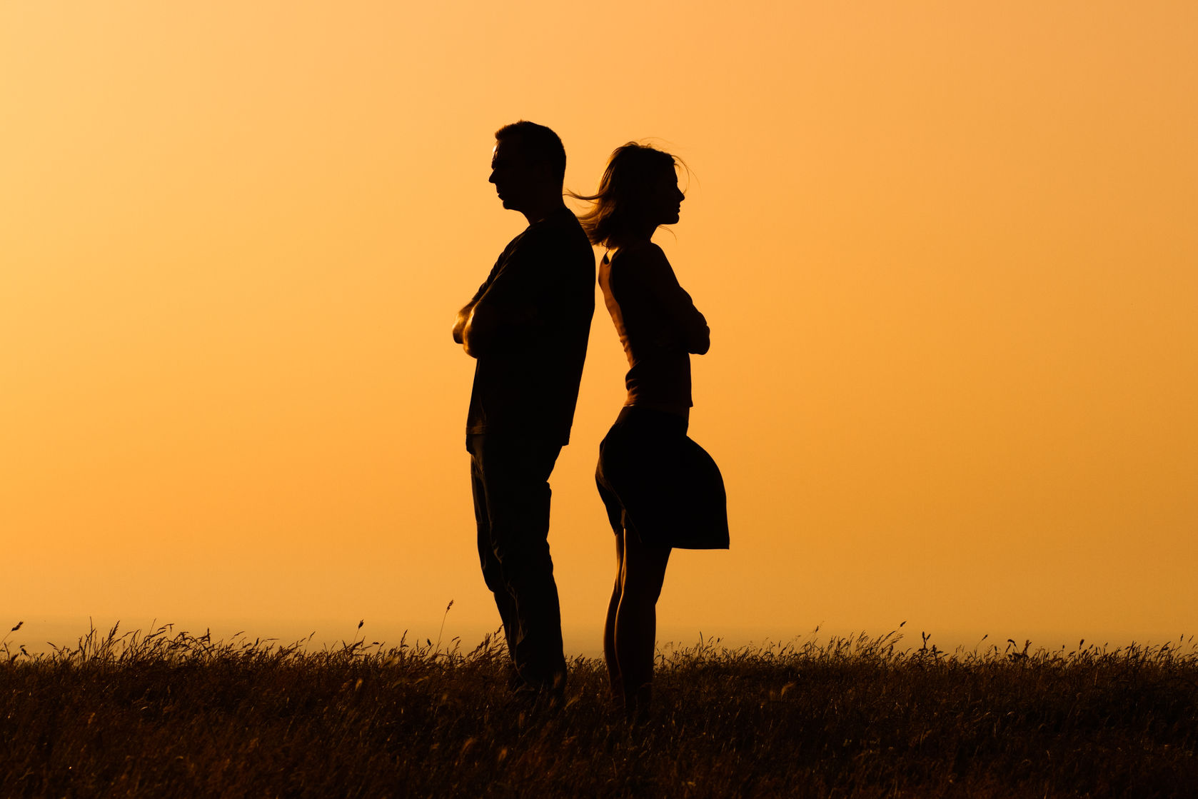 Silhouette of a angry woman and man facing away from each other