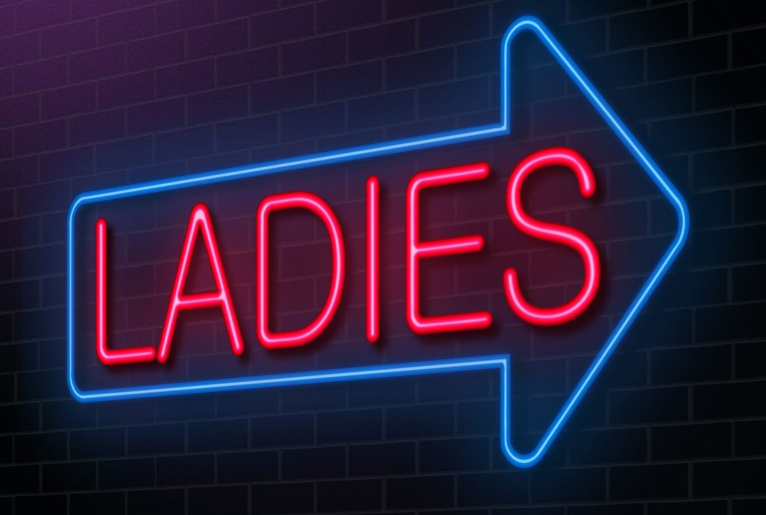 illuminated arrow sign depicting the word ladies