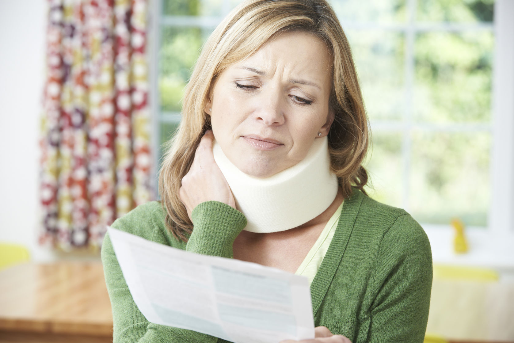 47816524 - woman reading letter after receiving neck injury