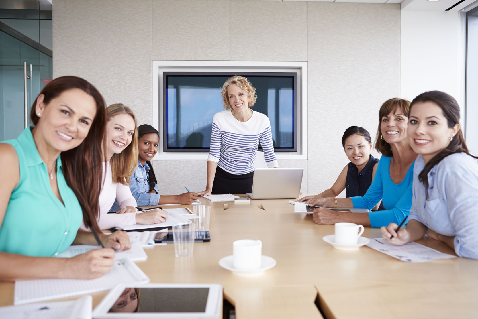 42314925 - group of businesswomen meeting around boardroom table