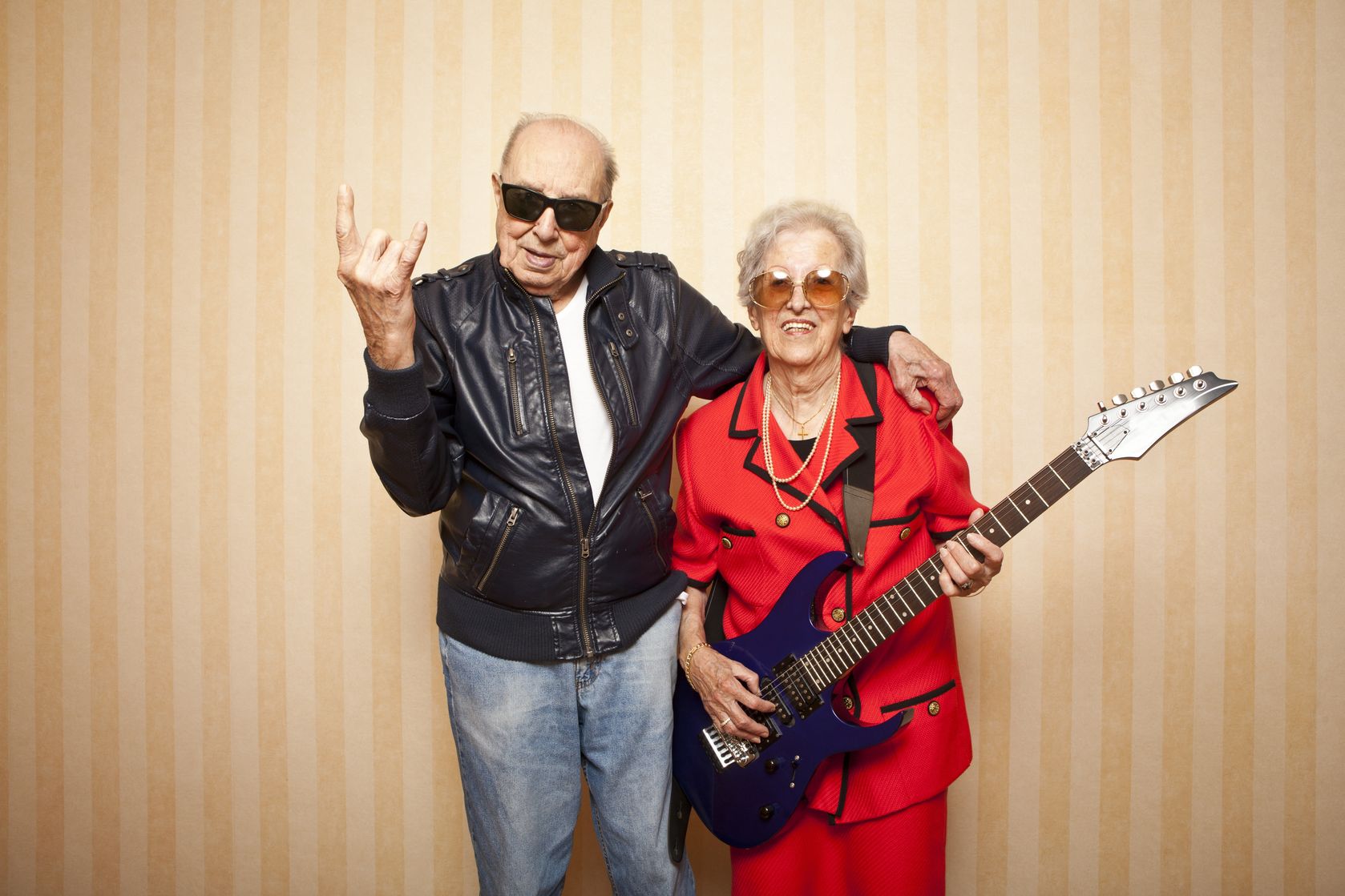 13787070 - cool fashion elder couple with electric guitar