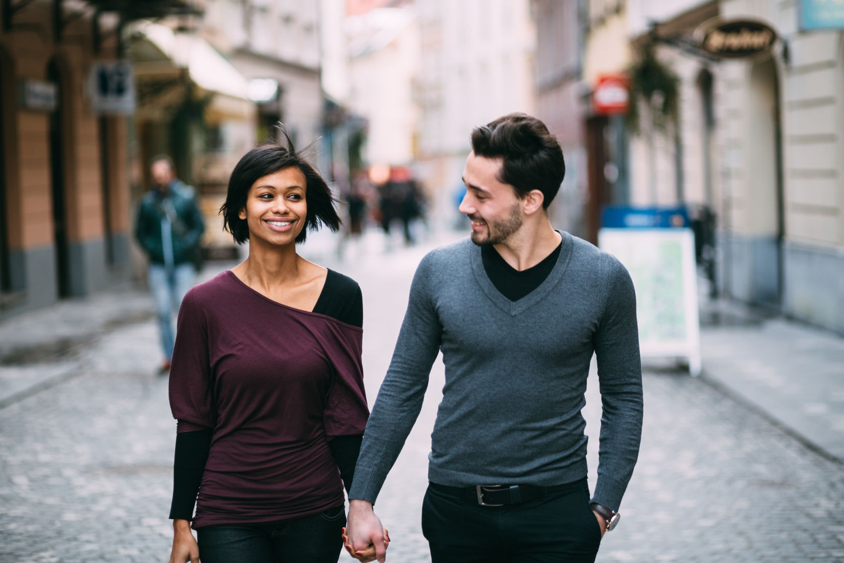 36766213 - interracial couple holding hands on the street