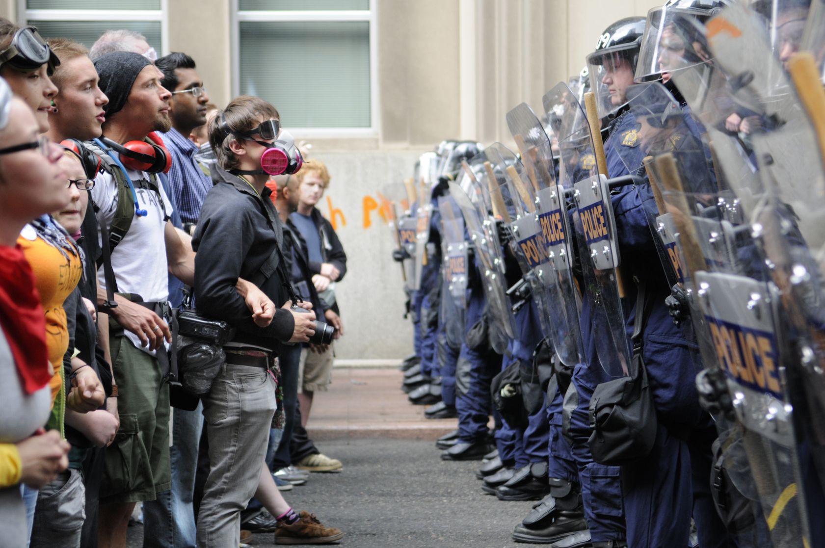 20263987 - toronto-june 26: toronto riot police (r) restrict protesters from entering g20 summit area at the metro convention centre on june 26, 2010 in toronto, canada.